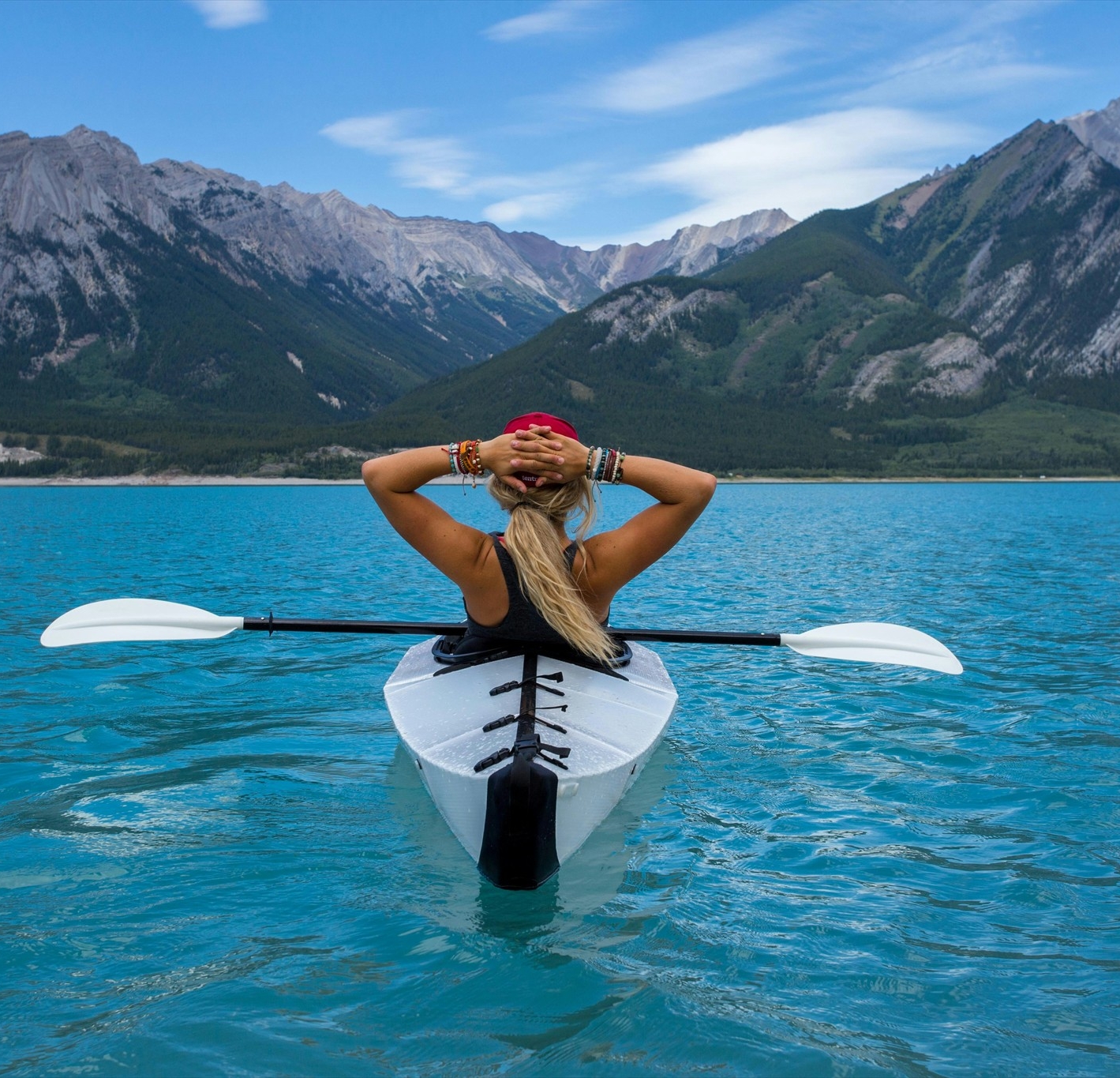 A woman kayaking in a lake.
